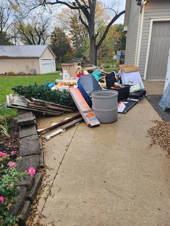 Dumpster being loaded with debris for Estate Cleanout Dumpster Rental in Hoffman Estates